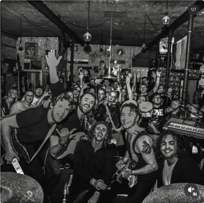 A band celebrating with a packed crowd at Peggy McCools
