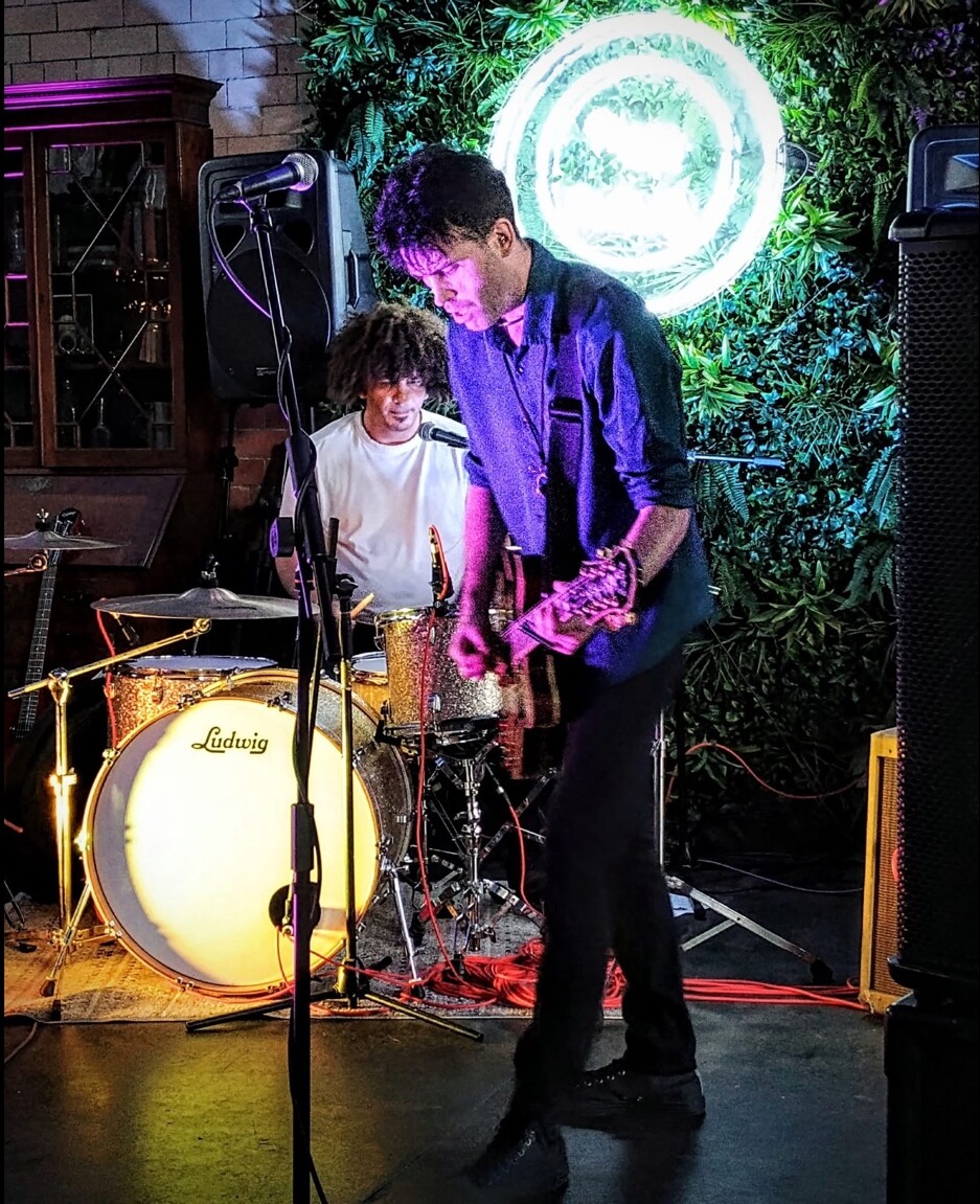A guitarist and drummer performing at Peggy McCools
